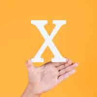 Free photo female hand showing the white alphabet x