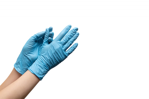 Female hands in disposable gloves on white background.