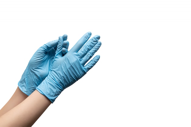 Free photo female hands in disposable gloves on white background.