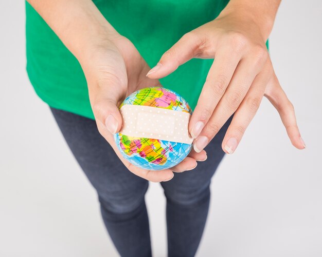 Female hands holding earth sphere