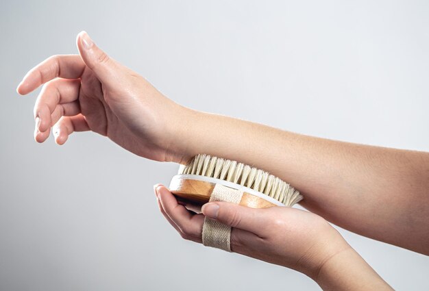 Female hands massage with a massage brush