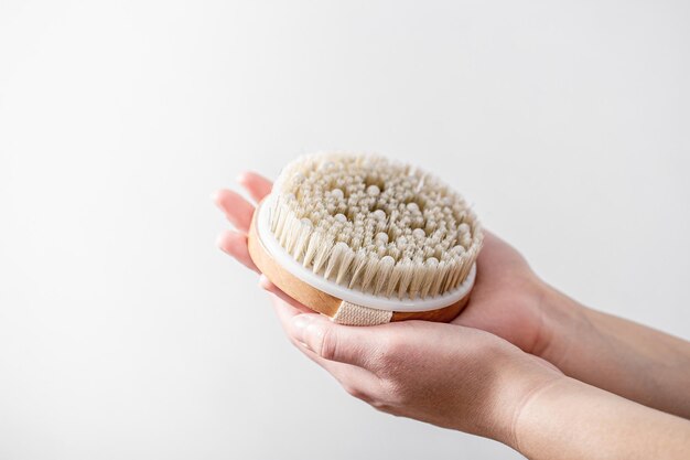 Female hands massage with a massage brush