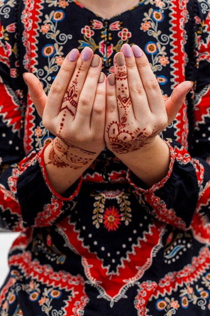 Female hands painted with mehndi