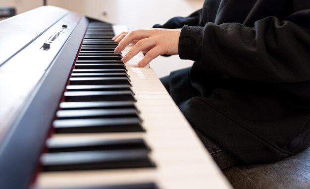 Female hands play musical keys soft focus