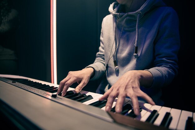 Female hands play the piano