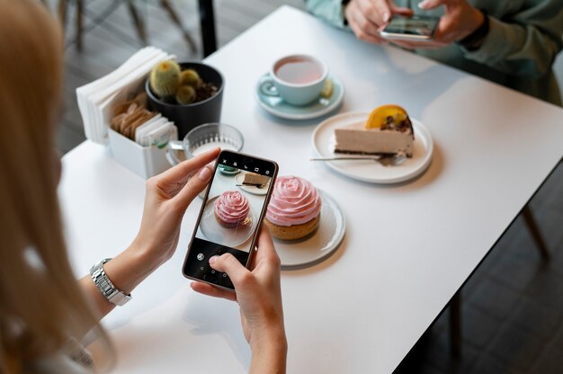 Female hands taking photo of a muffin