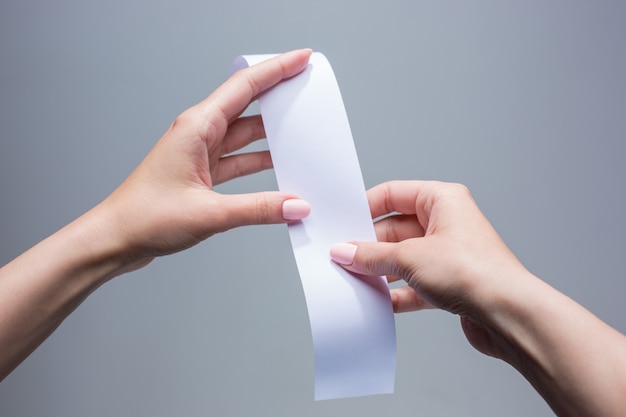 The female hands with  empty transaction paper or check