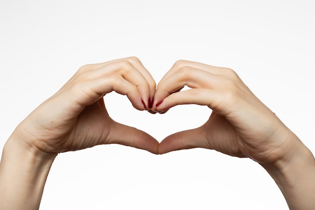 Female hands with a heart shape sign