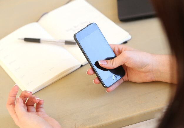 Female hands with phone