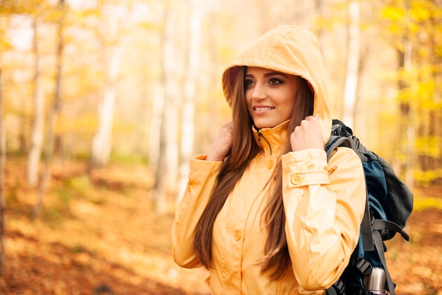 Female hiker protecting against rain