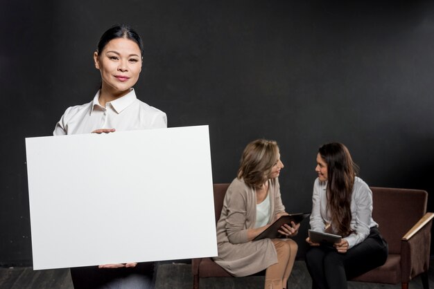 Female holding blank paper sheet