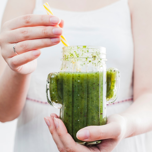 Female holding jar with healthy smoothie