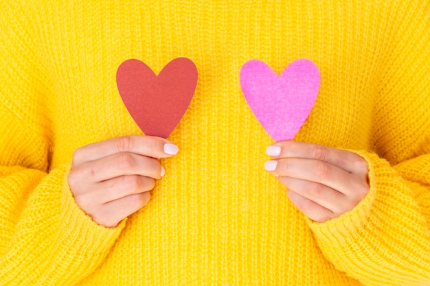 Female holding paper hearts front view