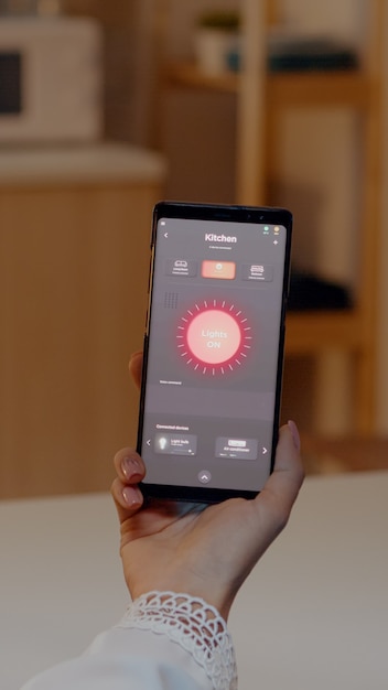 Female holding smartphone with lighting control application