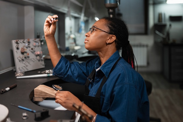 Female jeweler working in the shop