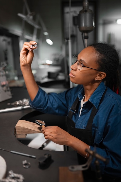 Female jeweler working in the shop