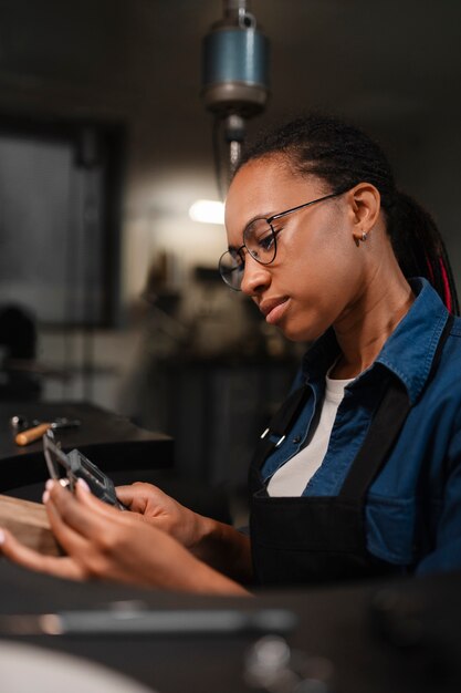 Female jeweler working in the shop