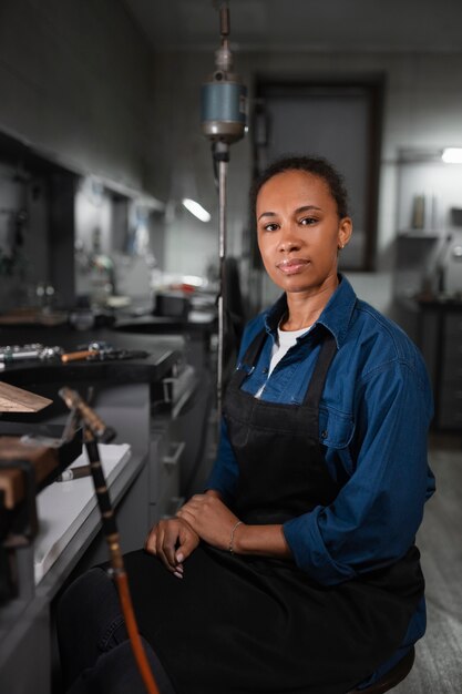 Female jeweler working in the shop