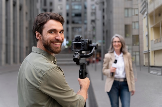 Female journalist with her cameraman