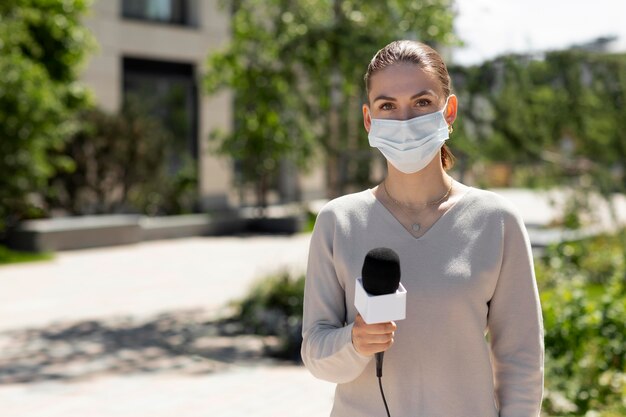 Female journalist with medical mask