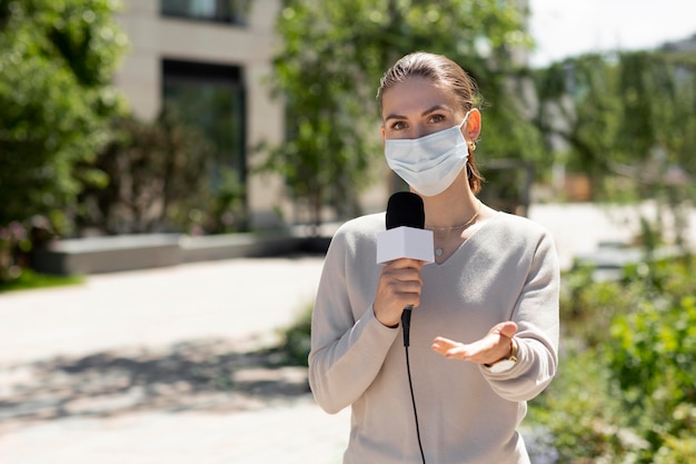 Female journalist with medical mask