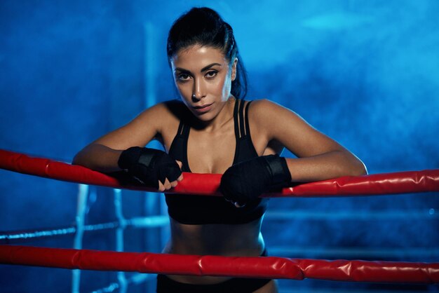 Female kickboxer having rest after training