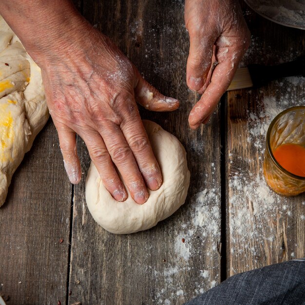 Female kneading dough with hands