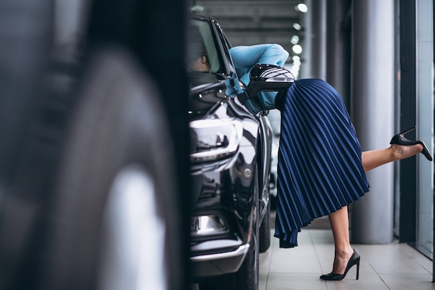 Female legs close up by the automobile