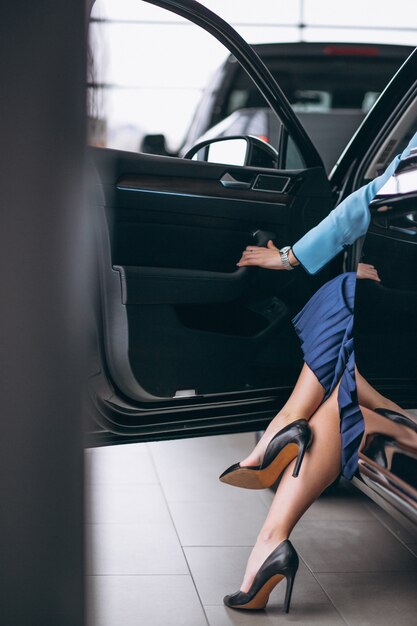 Female legs close up by the automobile