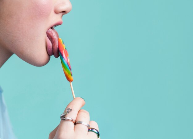 Female licking lollipop copy space