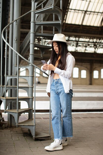 Free photo female local traveler checking her phone