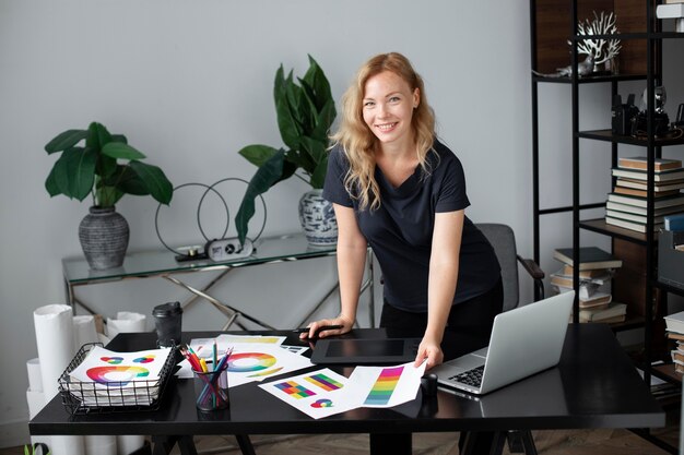 female logo designer working at her office on a graphic tablet