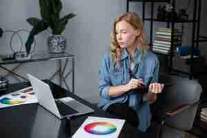 Free photo female logo designer working at her office on a graphic tablet