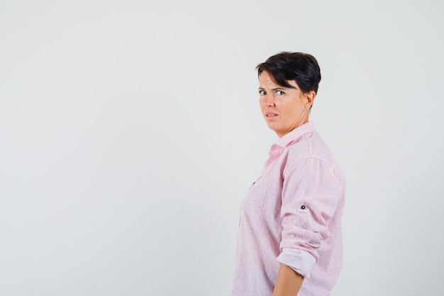 Female looking at camera in pink shirt and looking arrogant. .