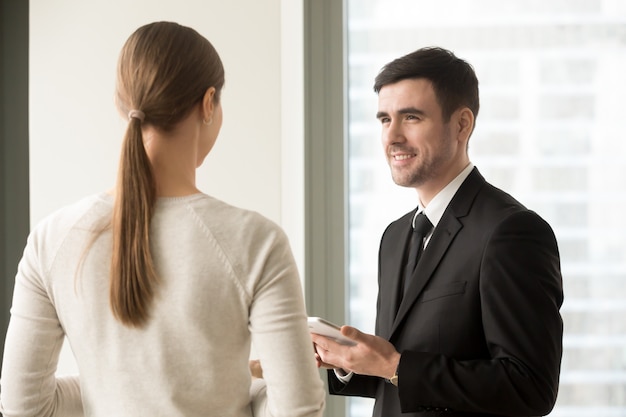 Female and male colleagues meeting in office