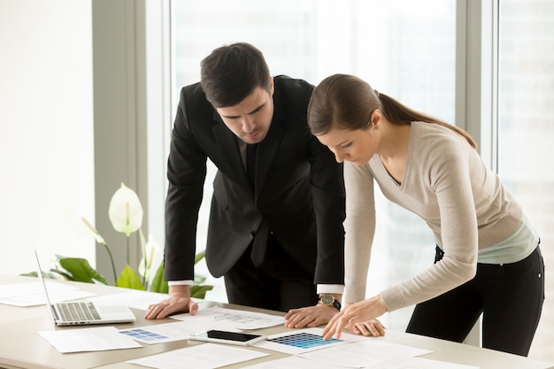 Female and male designers discussing colors scheme