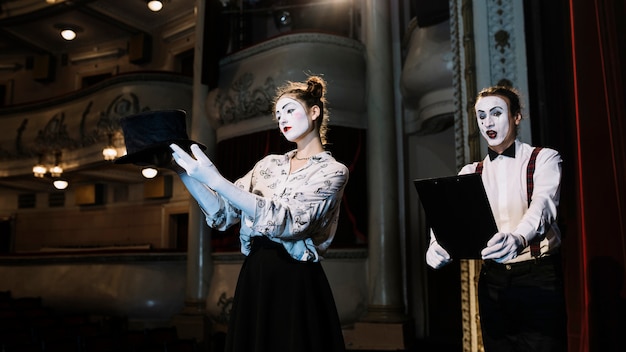 female and male mime artist rehearsing on stage in the auditorium