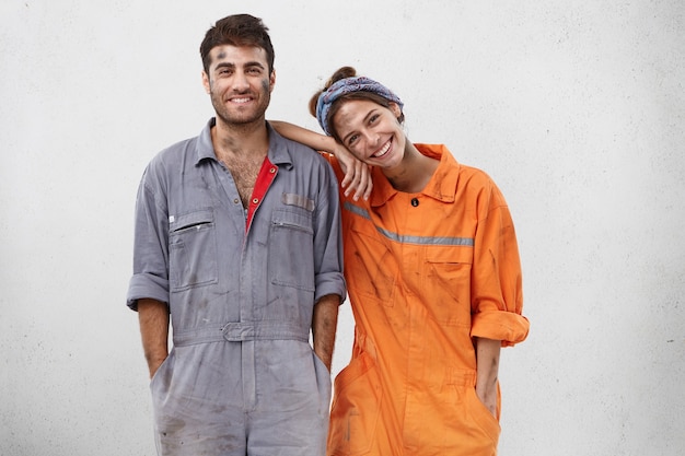 Free photo female and male workers wearing work clothes