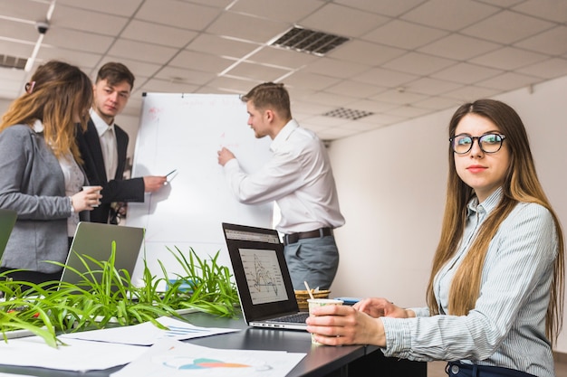 Female manager in front of colleague discussing business plan