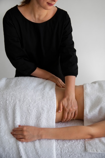 Free photo female masseur giving back massage to client