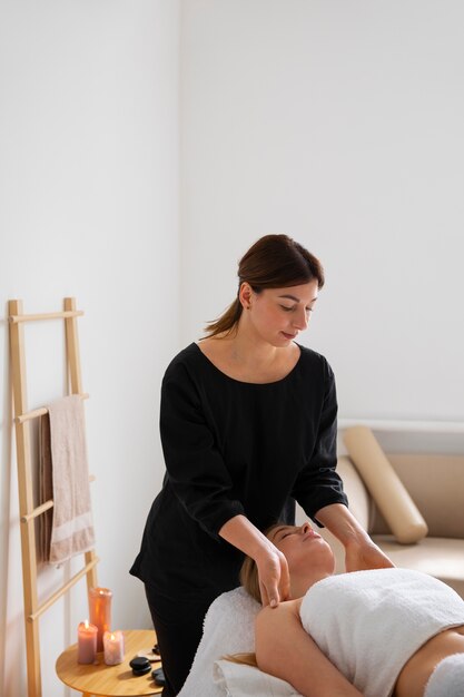 Female masseur giving back massage to client