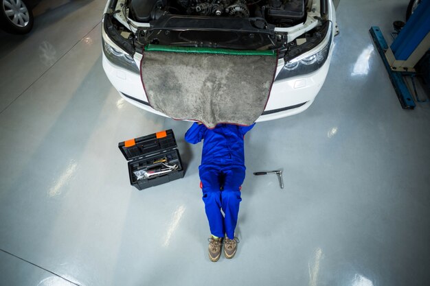 Female mechanic repairing a car