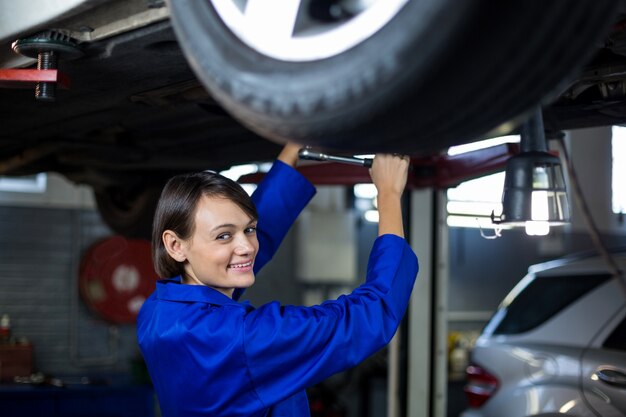 Female mechanic servicing a car