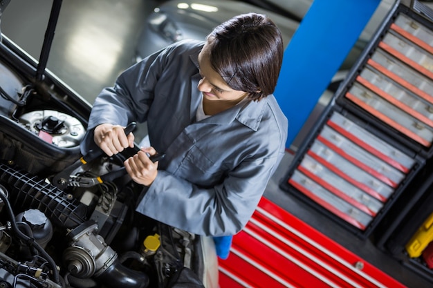 Free photo female mechanic servicing car