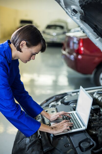 Female mechanic using laptop