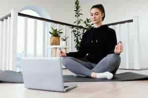 Free photo female meditating indoor