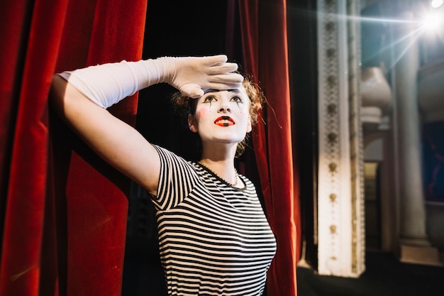 Free photo female mime artist shielding her eyes