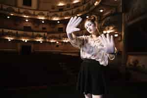 Free photo female mime showing stop gesture with her two palms