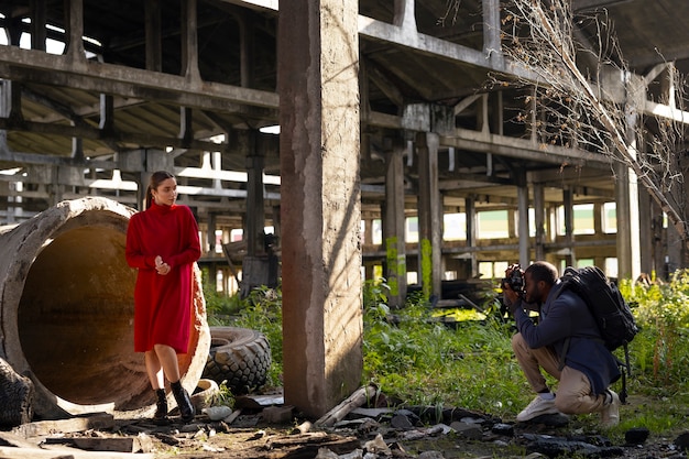 Female model being photographed with grunge environment during urban exploration