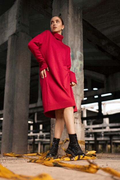 Female model being photographed with grunge environment during urban exploration